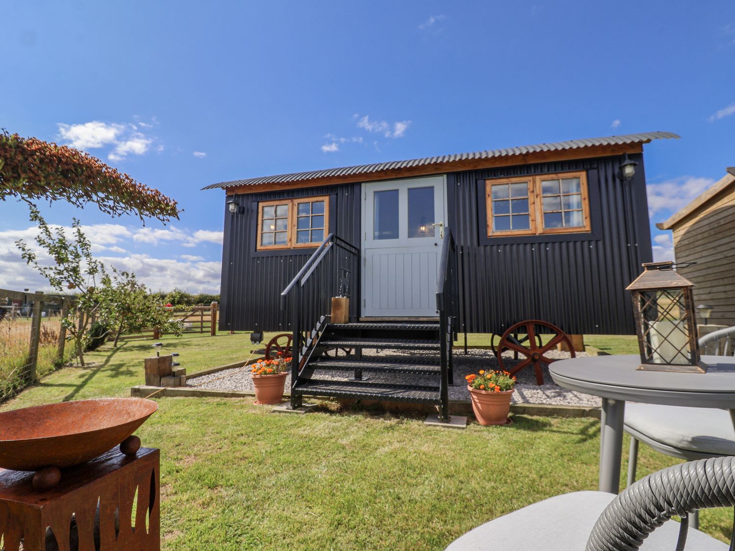 A mobile home with steps and landscaped outdoor area at Wolds Hoot in Market Weighton