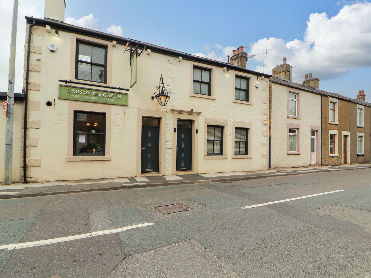 A building with a sign outside at Flat 1 in Carnforth
