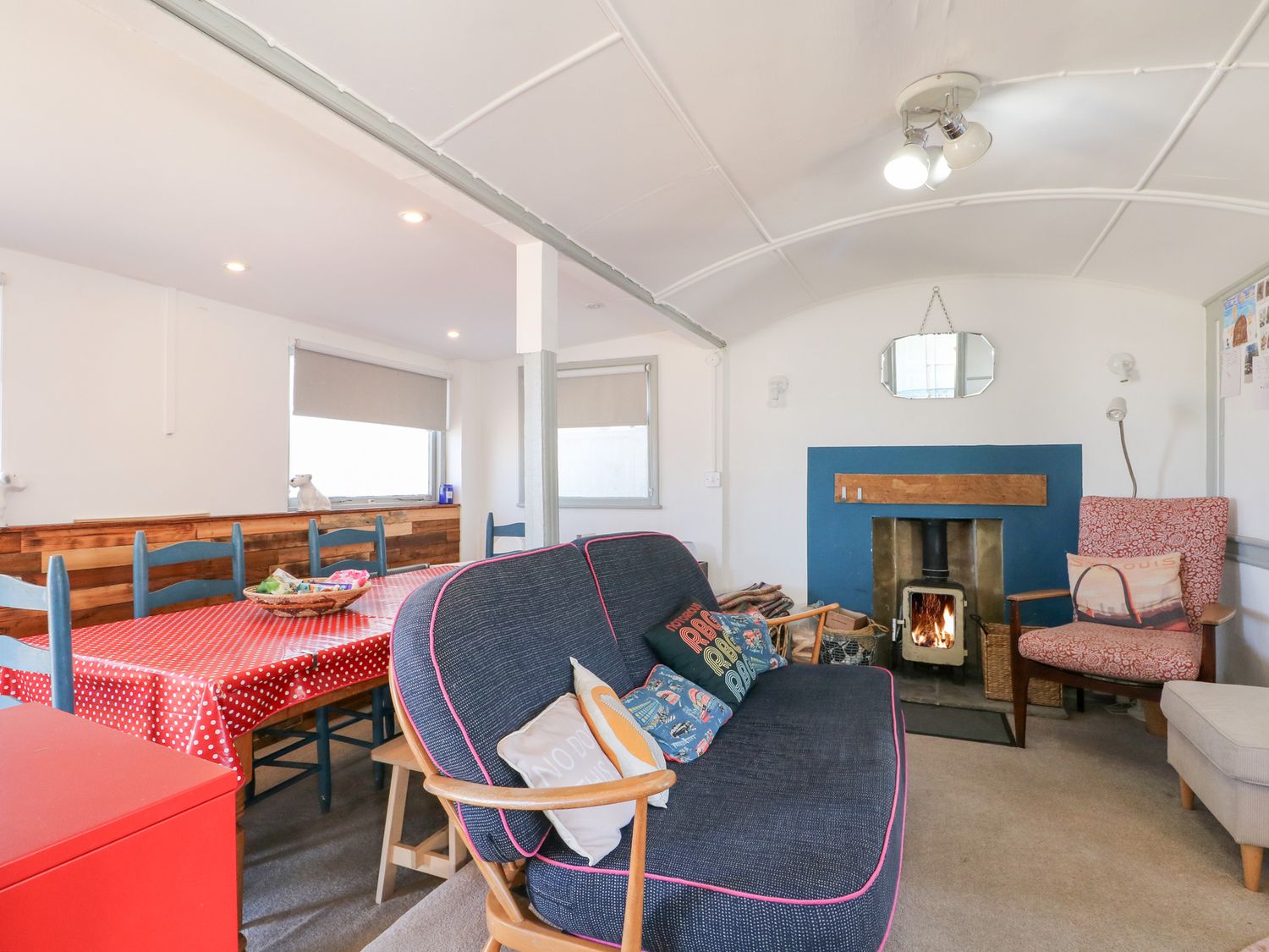 A living room with a sofa and a dining table at Harbour Road Quirky Beach Railway Carriages in Pagham