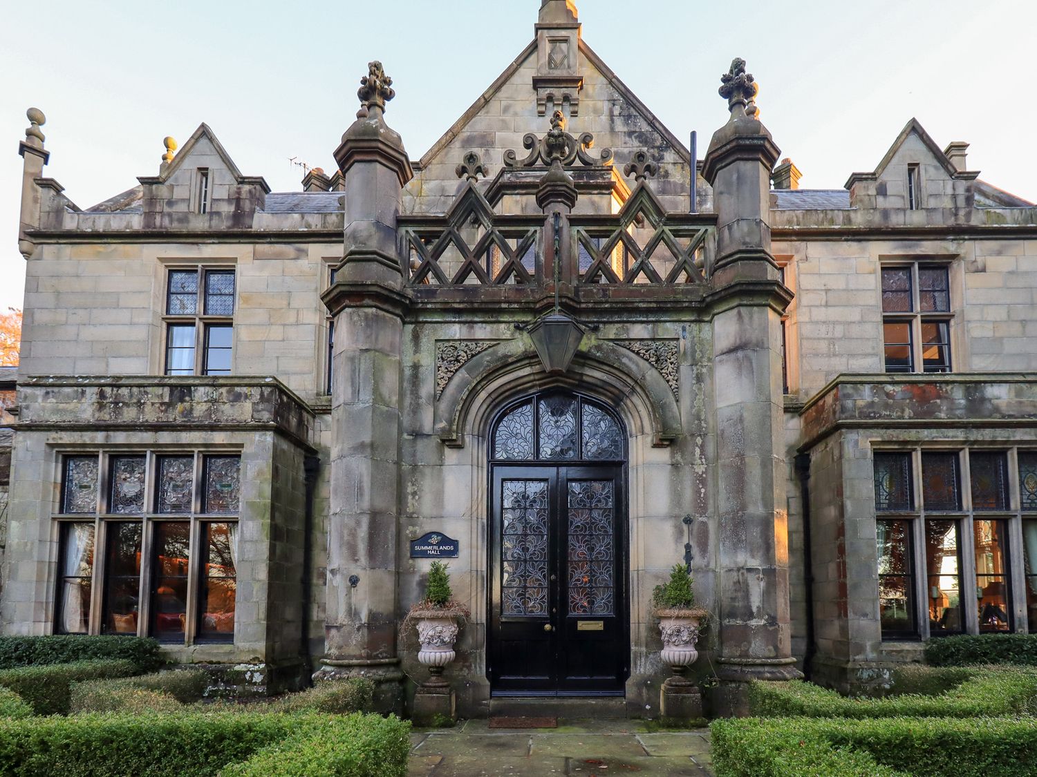 An entrance with stone facade and decorative features at Summerlands Hall Apartment