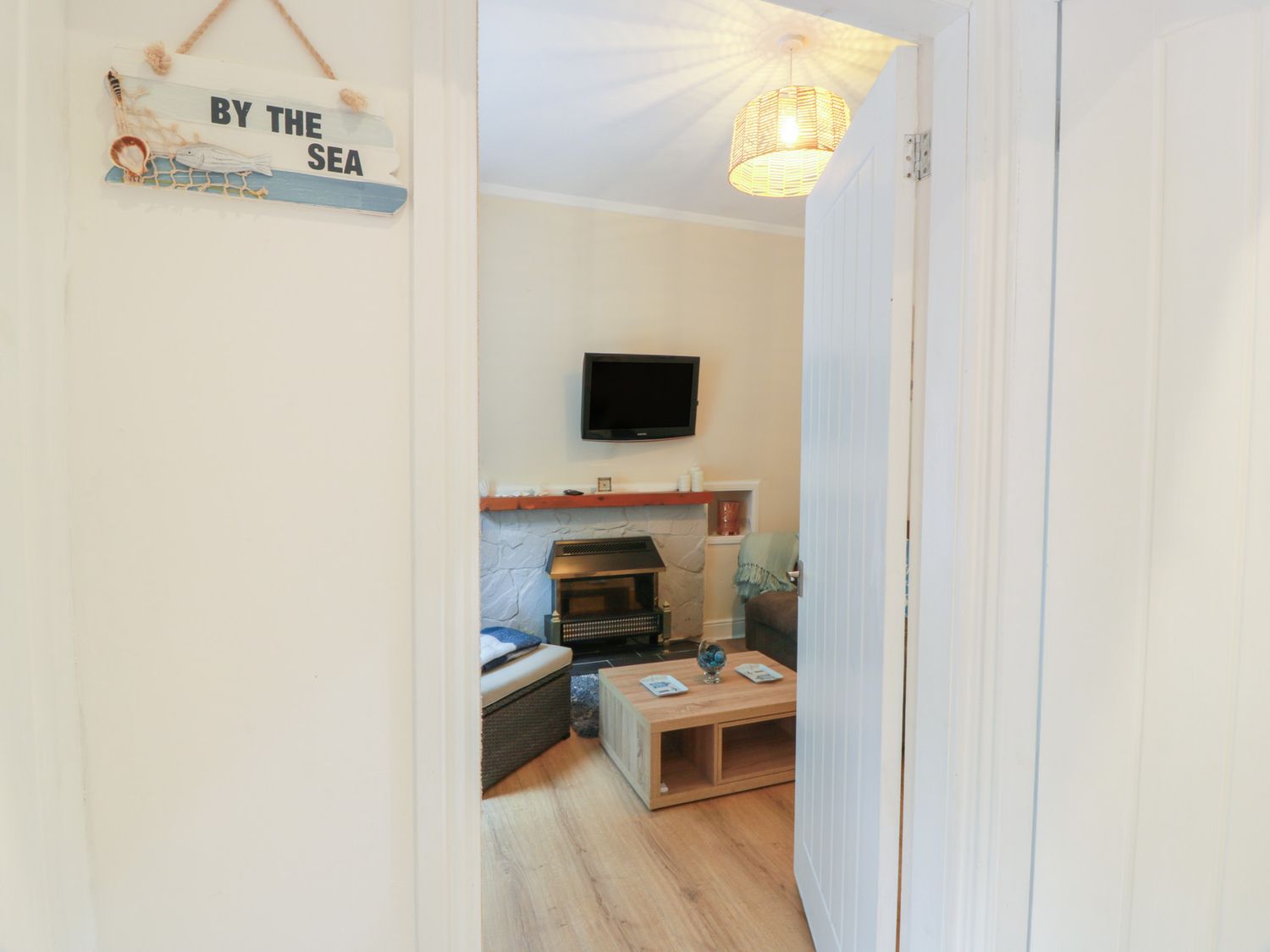 A living room with a television and fireplace at 6 George Street Isle of Cumbrae