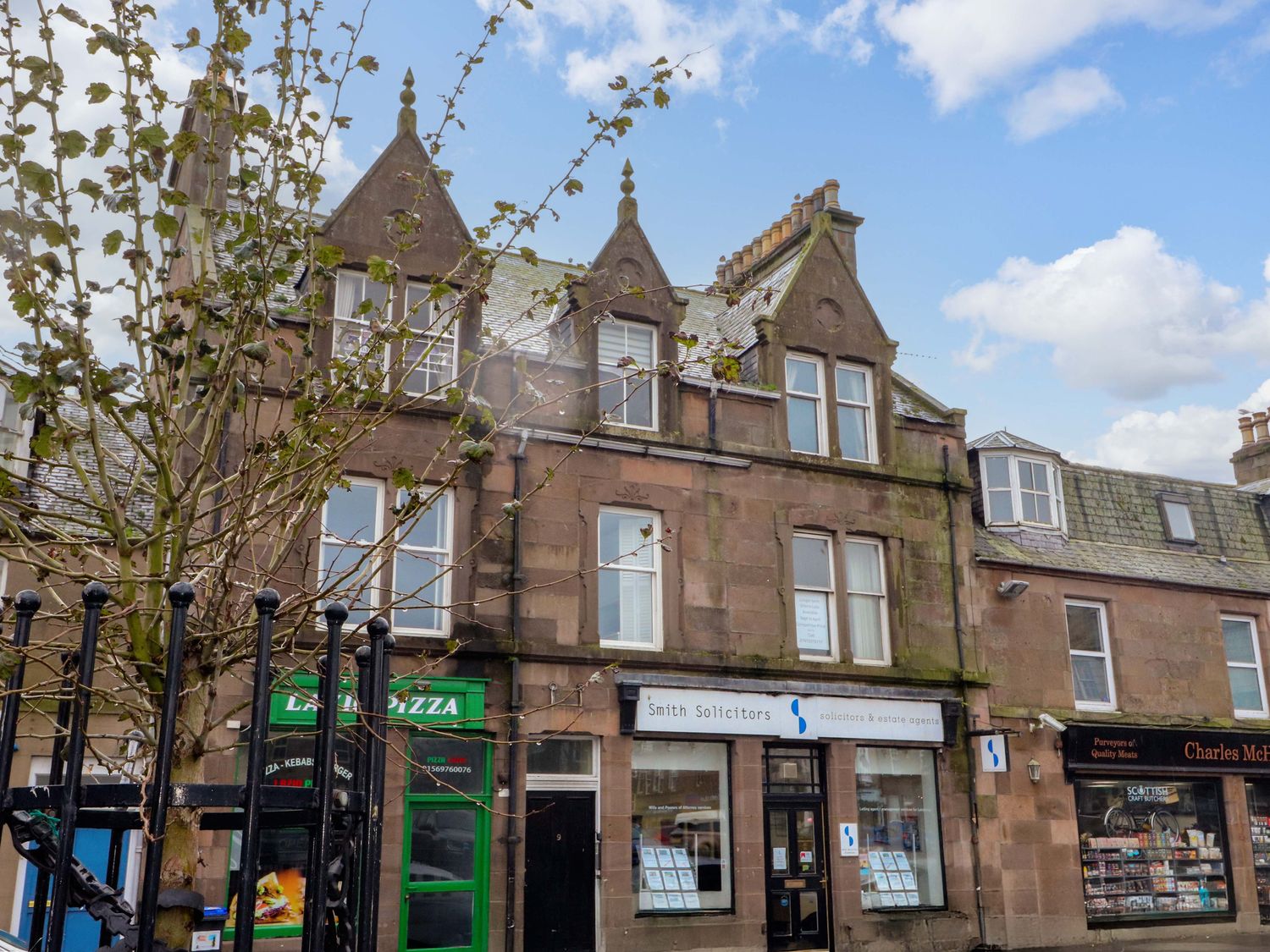 A street view of buildings with shops at 9A Market Square