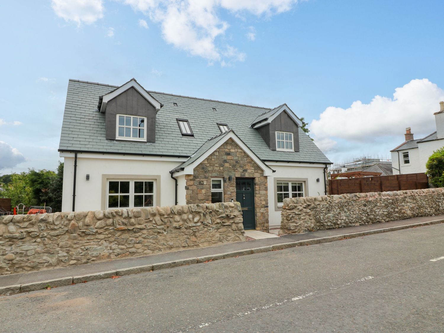 A house with a stone wall and windows at Riverwood House in Gatehouse Of Fleet
