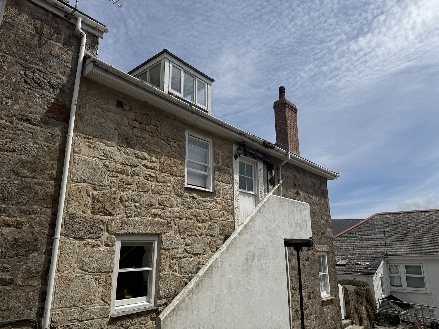 A building with stone walls and windows at Crows Nest in St Ives