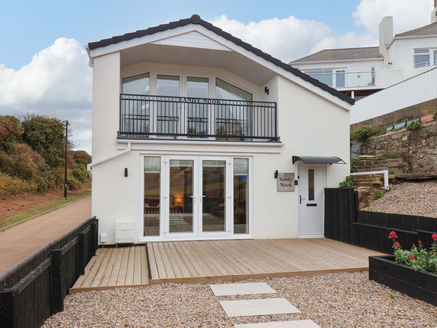 A house with a balcony and garden area at Sandy Nook in Redcar