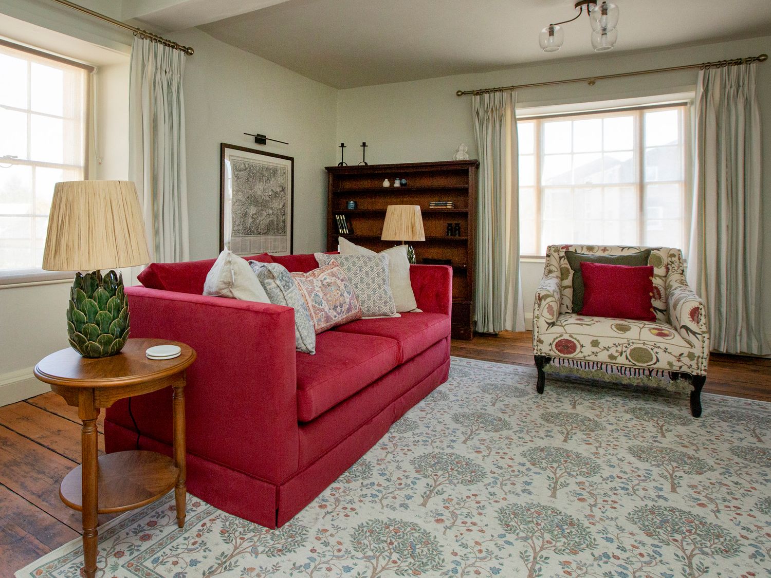 A living room with a sofa and armchair at Apartment 2, 86 Dyer Street in Cirencester