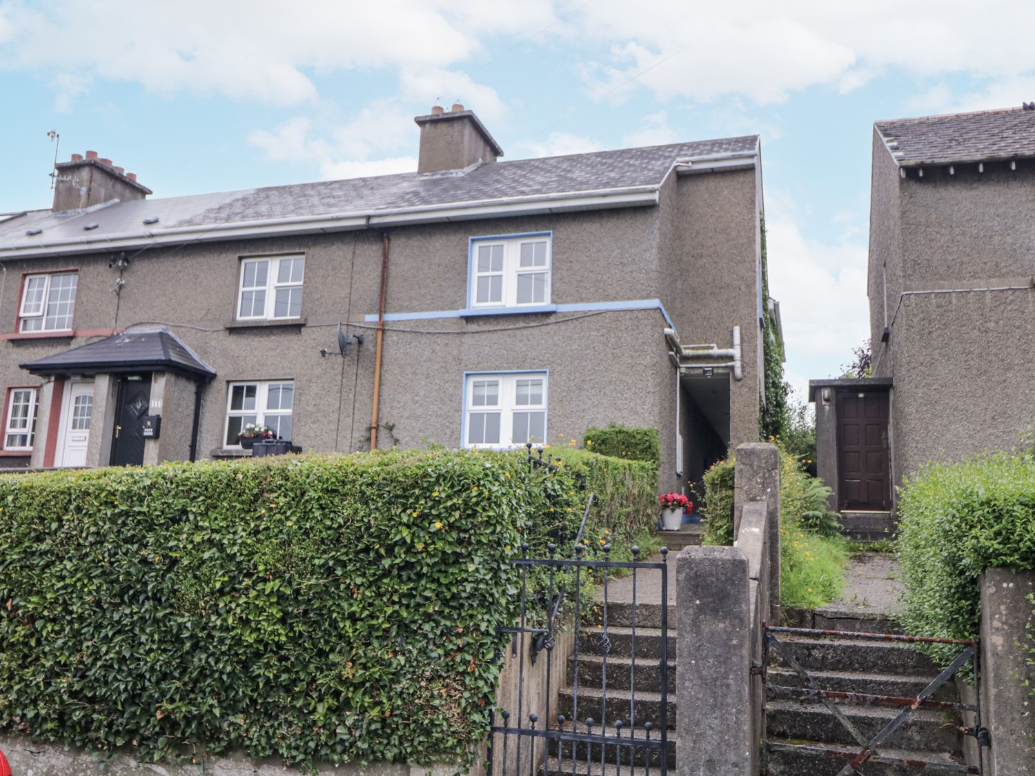 A house with a hedge and steps at Burna Letterkenny