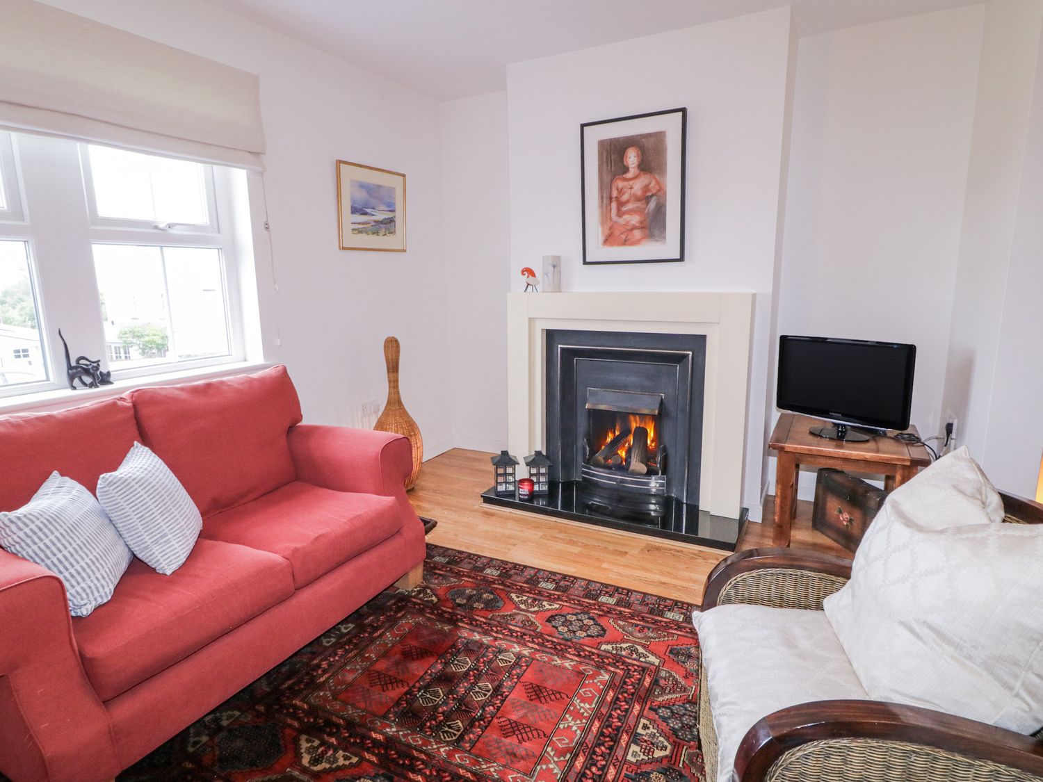 A living room with a sofa and fireplace at Burna in Letterkenny