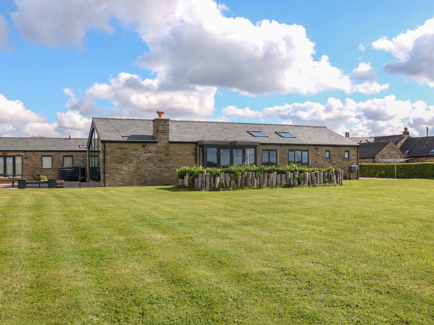 A house with a garden and grass at Highgate house in Holmesfield near Dronfield
