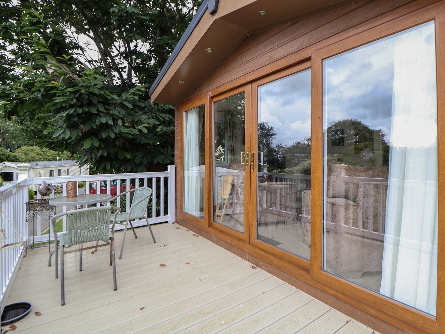 A deck with a table and chairs at 96 Ruthin