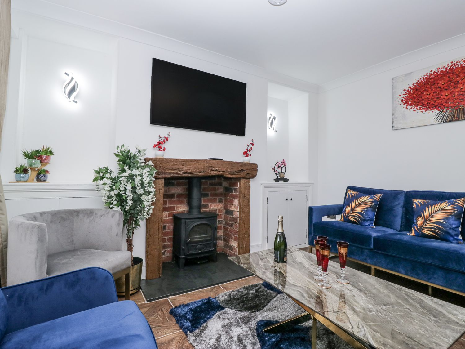 A living room with a fireplace and sofa at Aspen Boutique