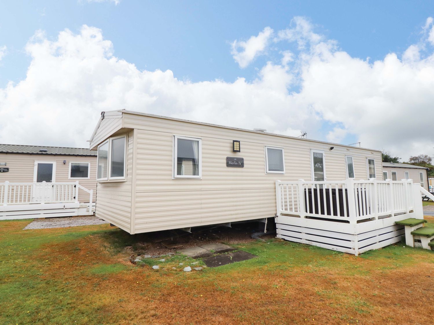 A caravan with steps and railings at Beachcombers Barmouth Bay Holiday Park Talybont