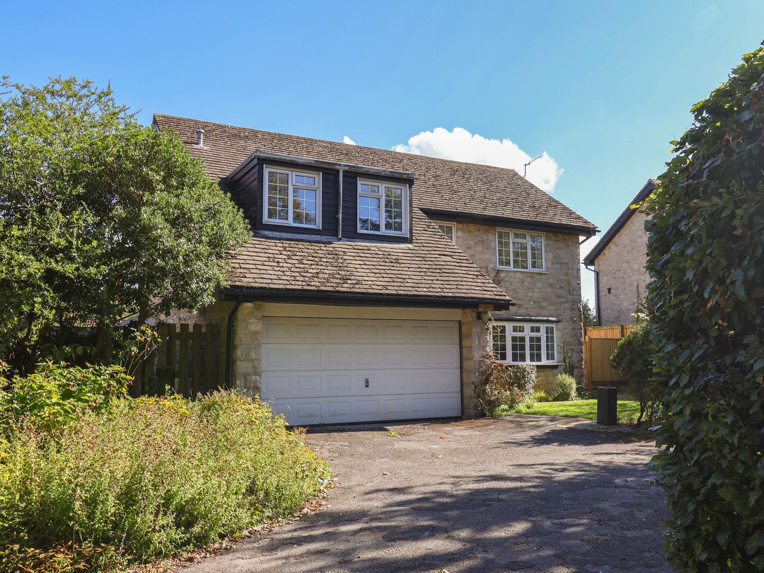 A house with a garage and a driveway at Oakwood in Chideock