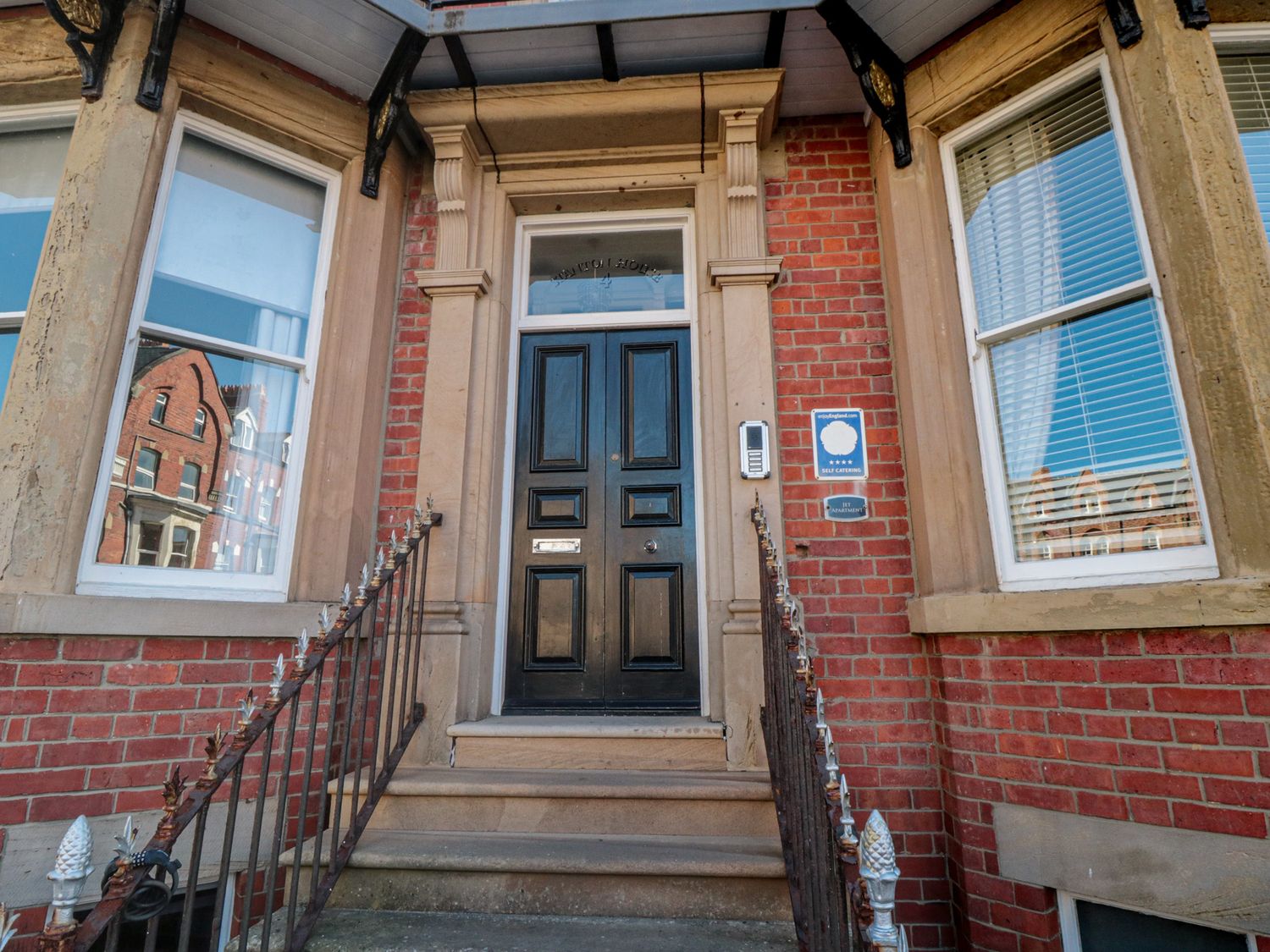 An entrance with a black front door and steps at Stanton House - Abbey View, Flat 3