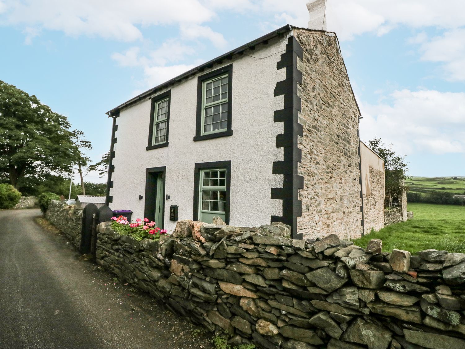 A house with windows and a door at Holy Trinity Cottage in Millom