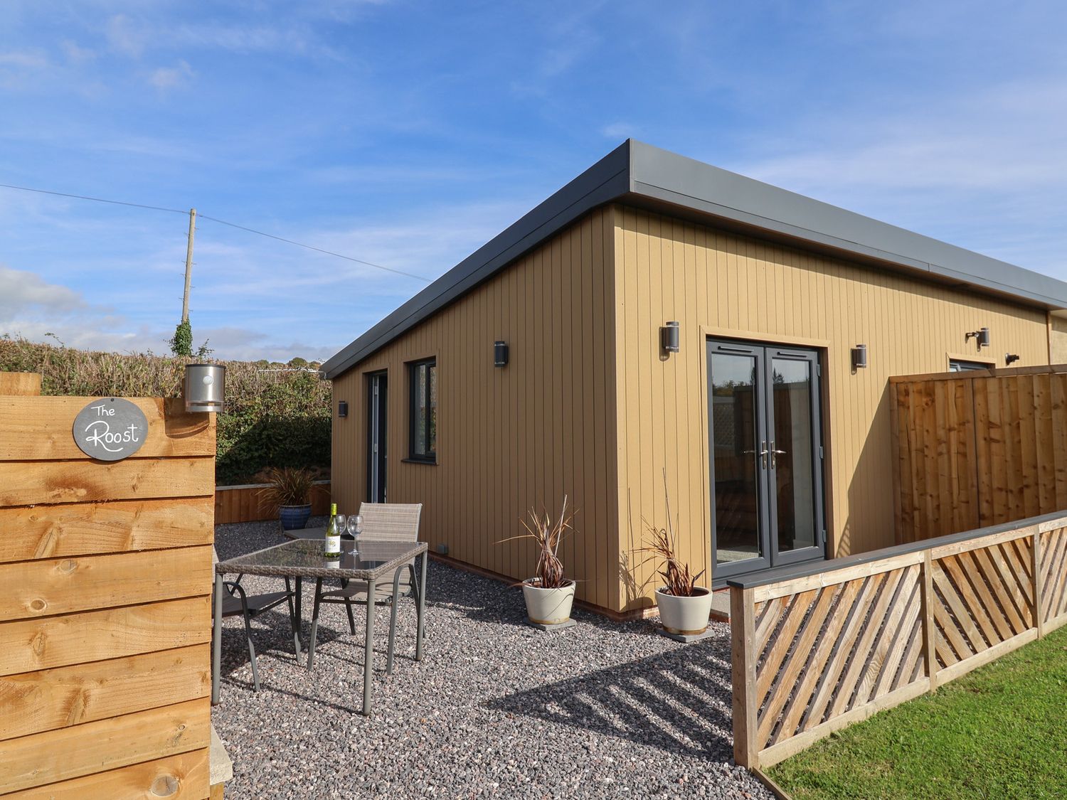 An outdoor area with a table and chairs at The Roost in Whitford Nr. Colyton