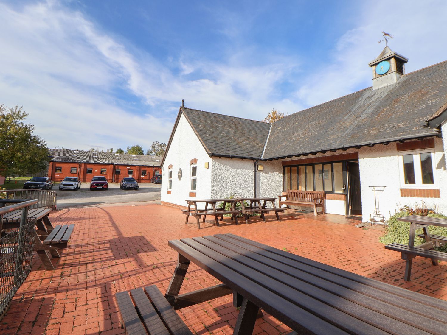 An outdoor area with tables and benches at Clwyd Special Riding Centre