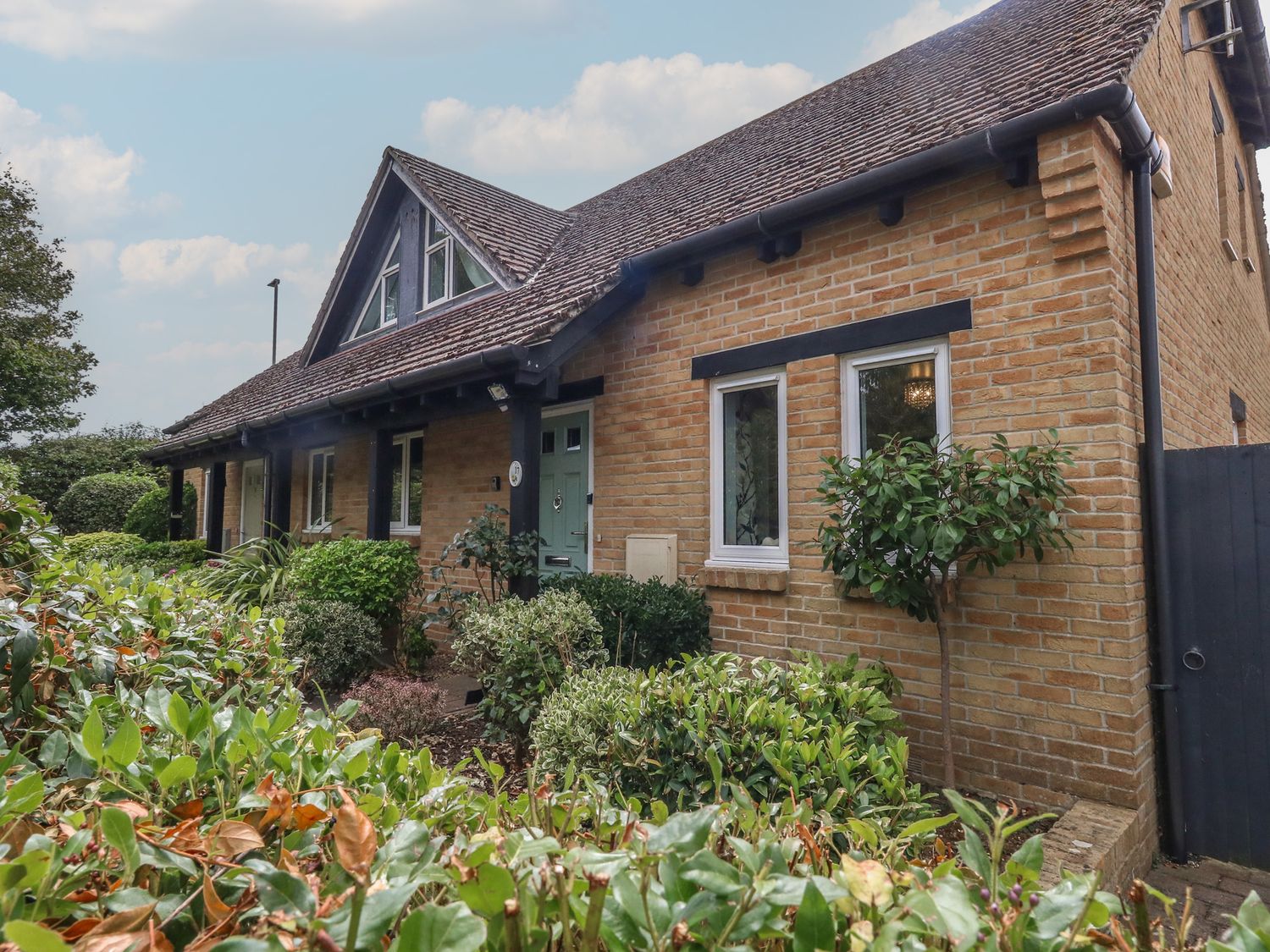 A house with windows and a garden at June Cottage in Wool