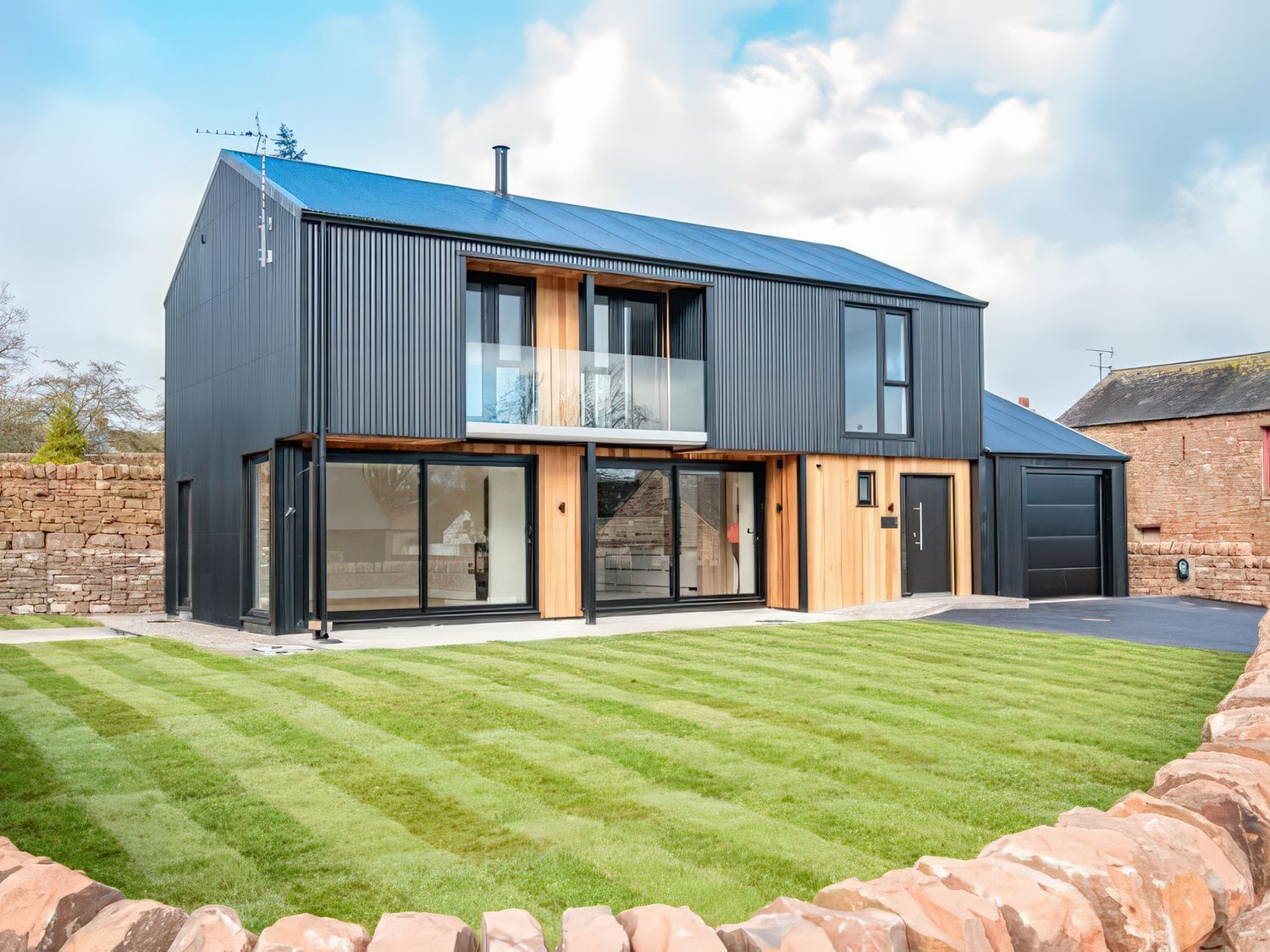 A house with large windows and grass area at the property in 