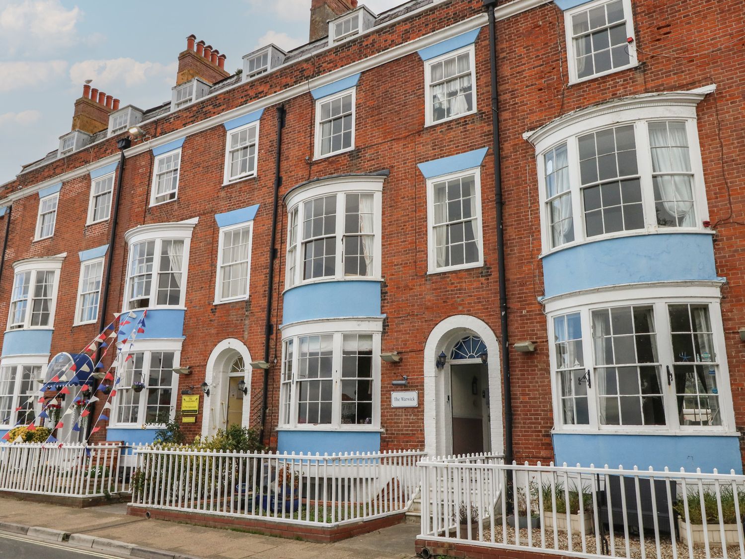 A building facade with multiple windows and a front door at 9 The Esplanade
