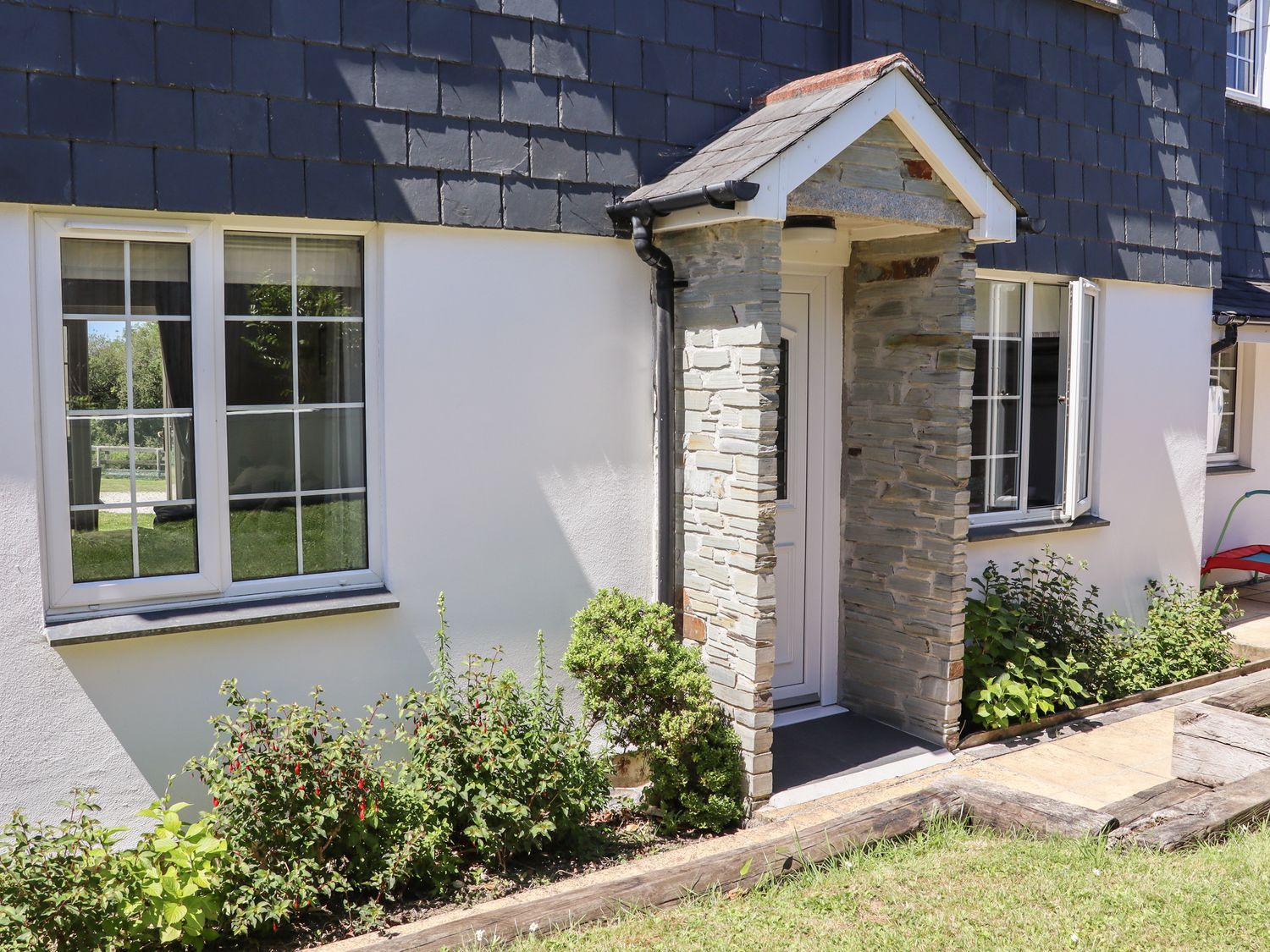 An entrance area with door and windows at Atlantic View (1 bed) Bude
