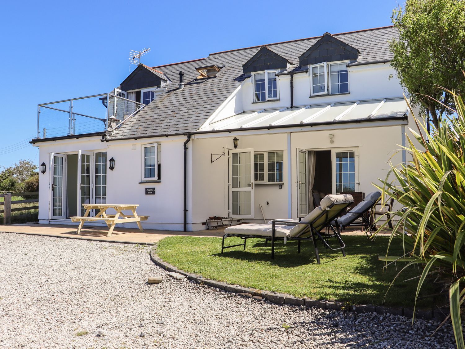 An outdoor area with seating and greenery at Atlantic View (3 bed) Bude