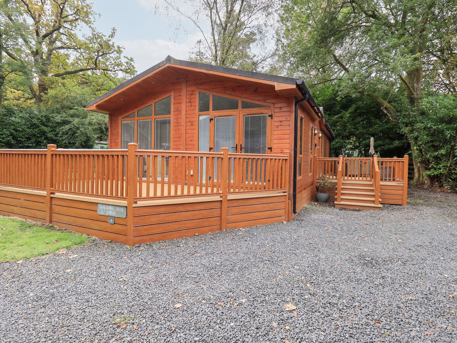 A lodge with decking and steps at Laughing Duck in Troutbeck Bridge