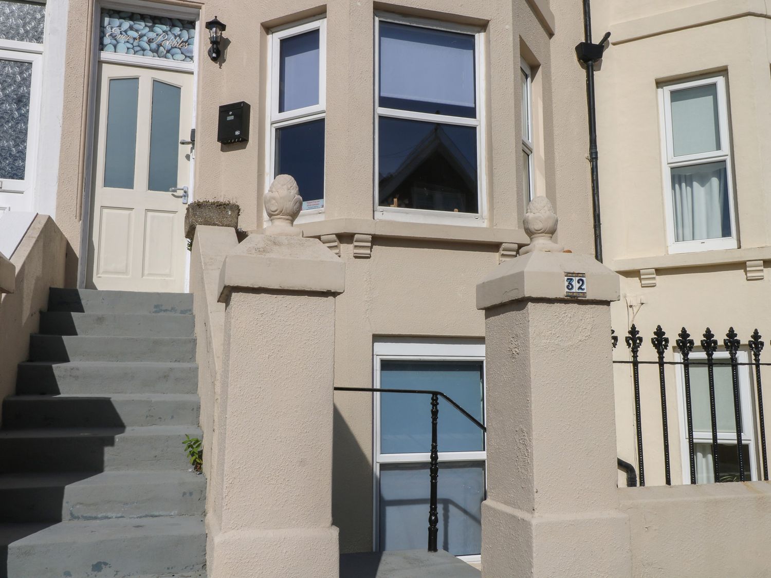 An entrance with a door and steps at Pebbles in Eastbourne