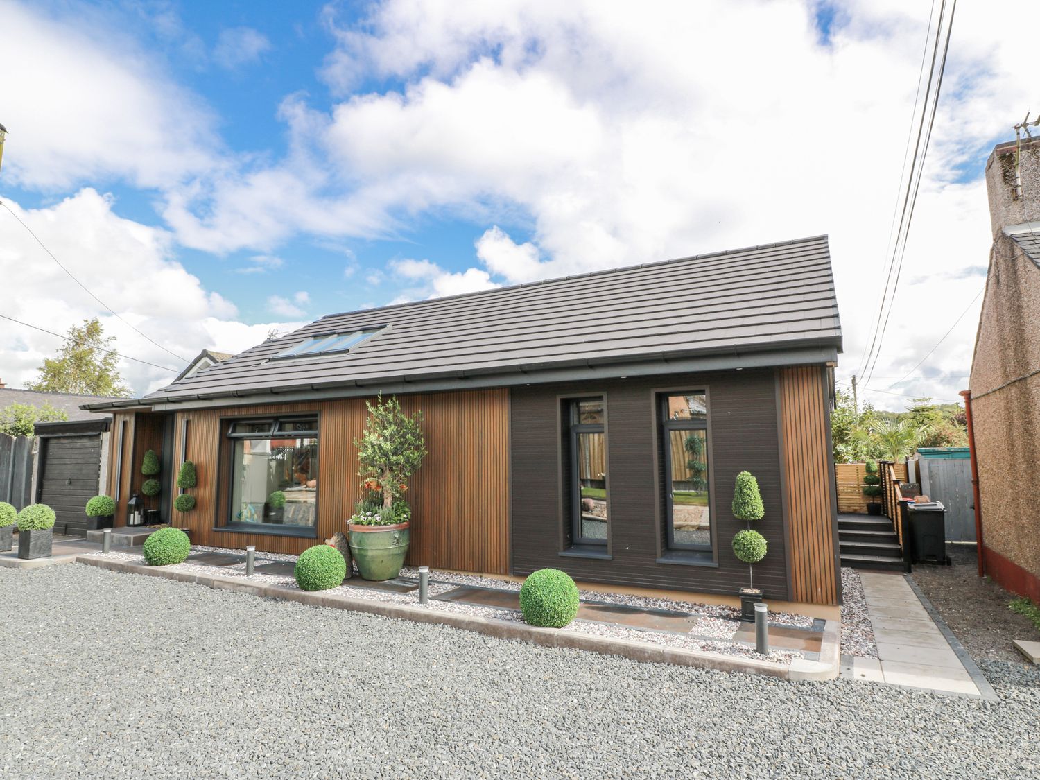 A house with windows and plants in the front yard at Scotia At The Brig Annan