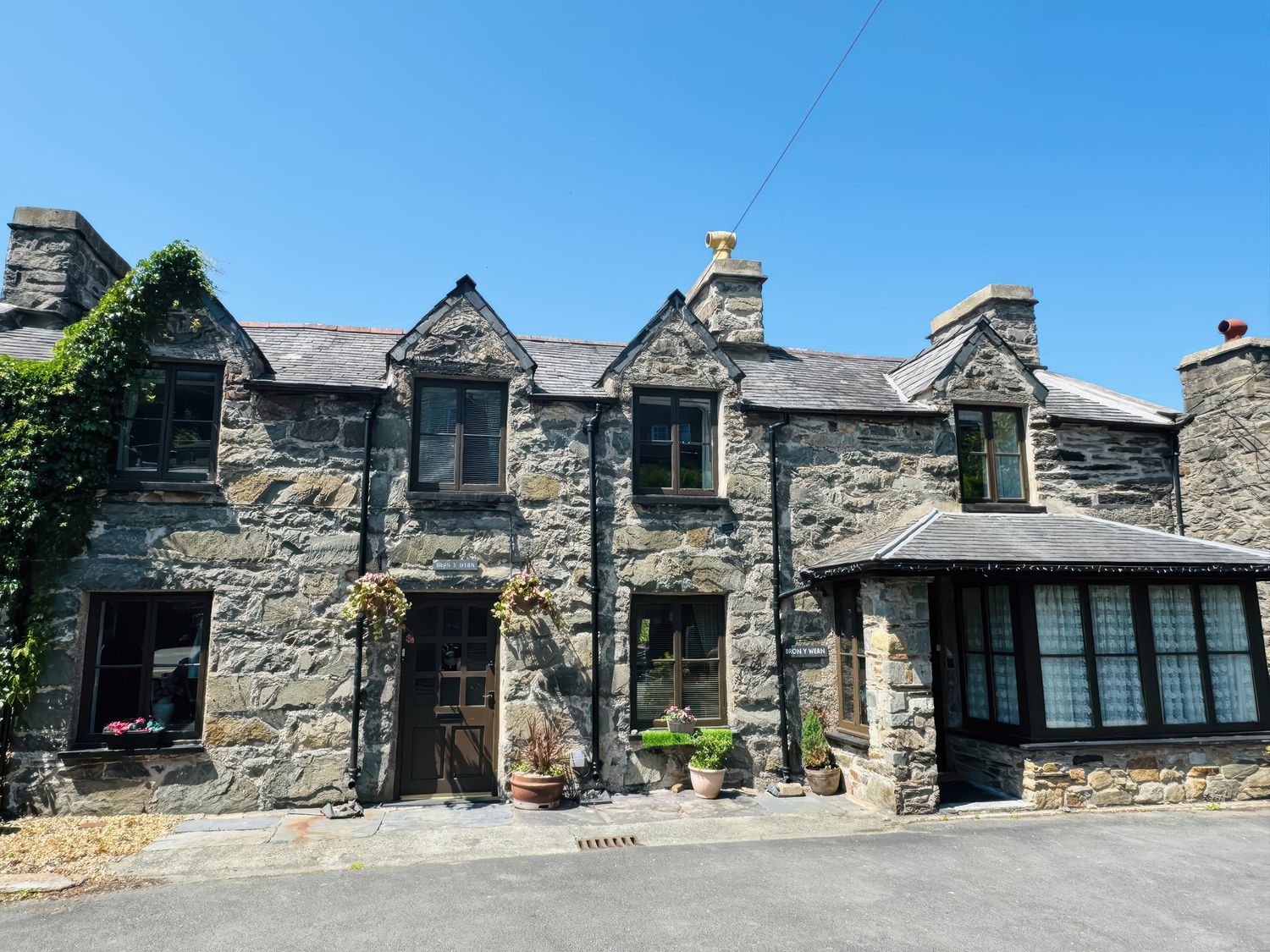 A stone house with door and windows at The Old Post Office in null