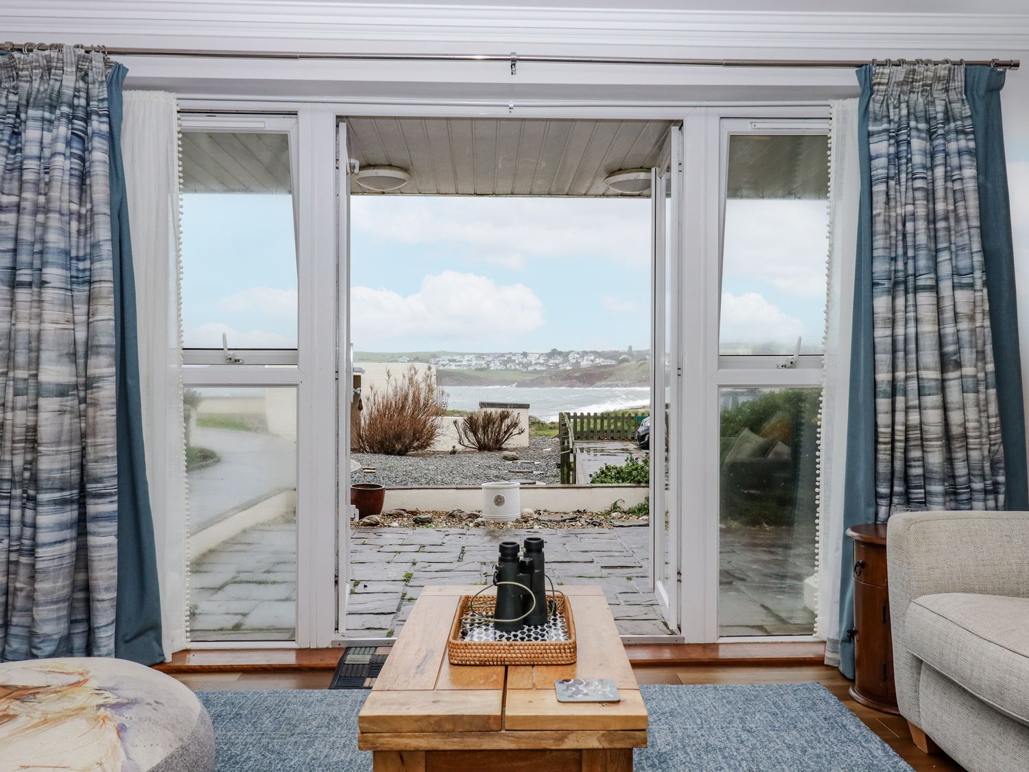 A living room with sliding doors and a view at 8 Thurlestone Rock in Kingsbridge