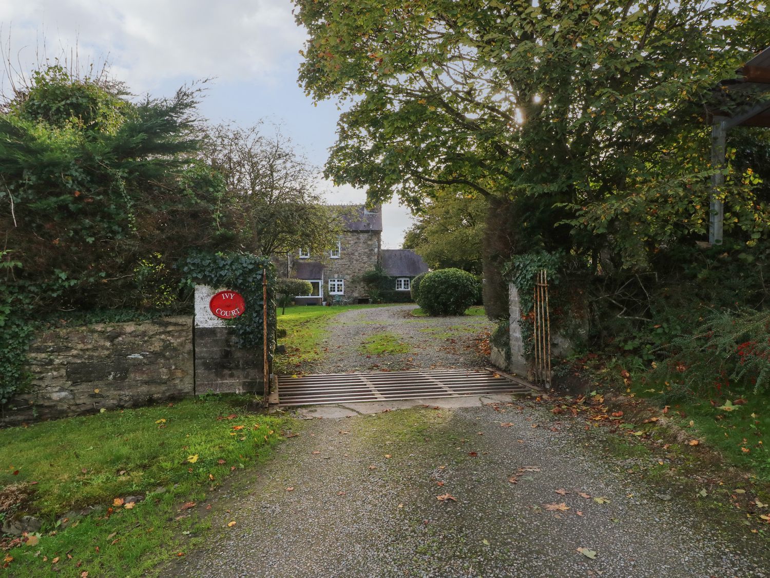 An entrance with a gate leading to a house at Ivy Court in Clarbeston Road
