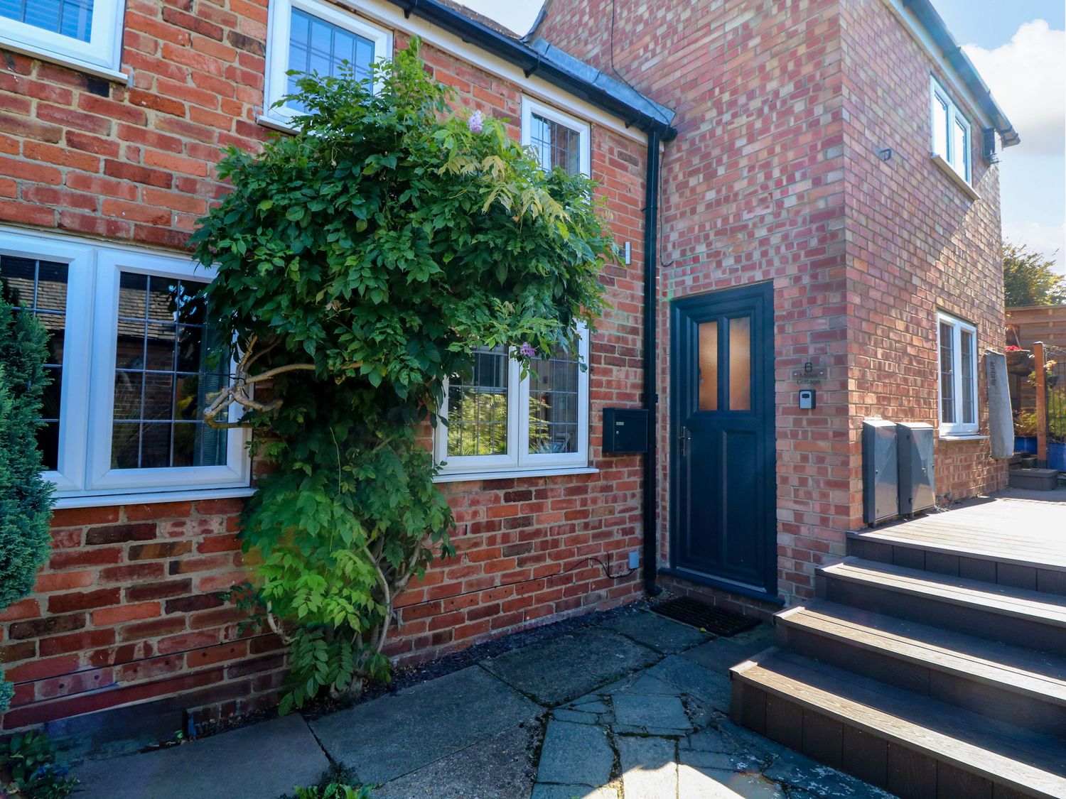 An outdoor area with a door and brick wall at 6 Brook Court Thulston near Derby
