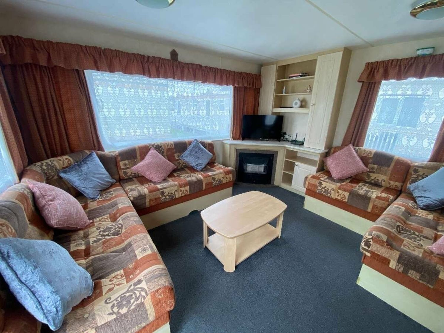 a living room with seating and a television at Seaview Caravan Park - Holiday Accommodation 18940 in Ingoldmells
