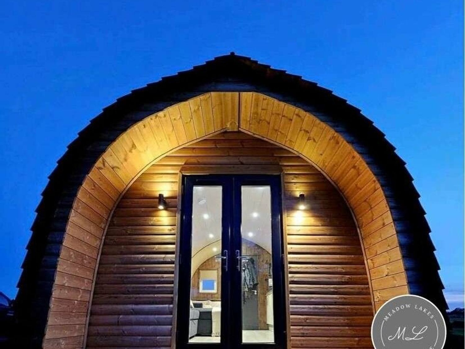 a wooden cabin with an arched roof and double doors at Standen Lodge - Holiday Accommodation 19045, Mablethorpe