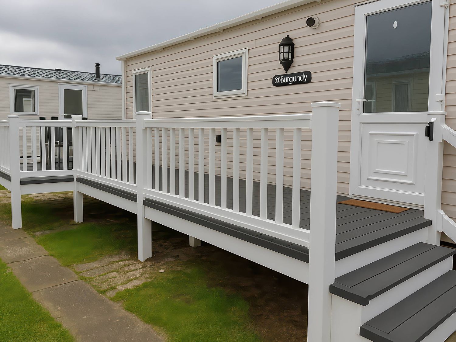 An outdoor deck with steps leading to a door at Whitehouse Leisure Park - Holiday Accommodation 19055, Towyn, Abergele