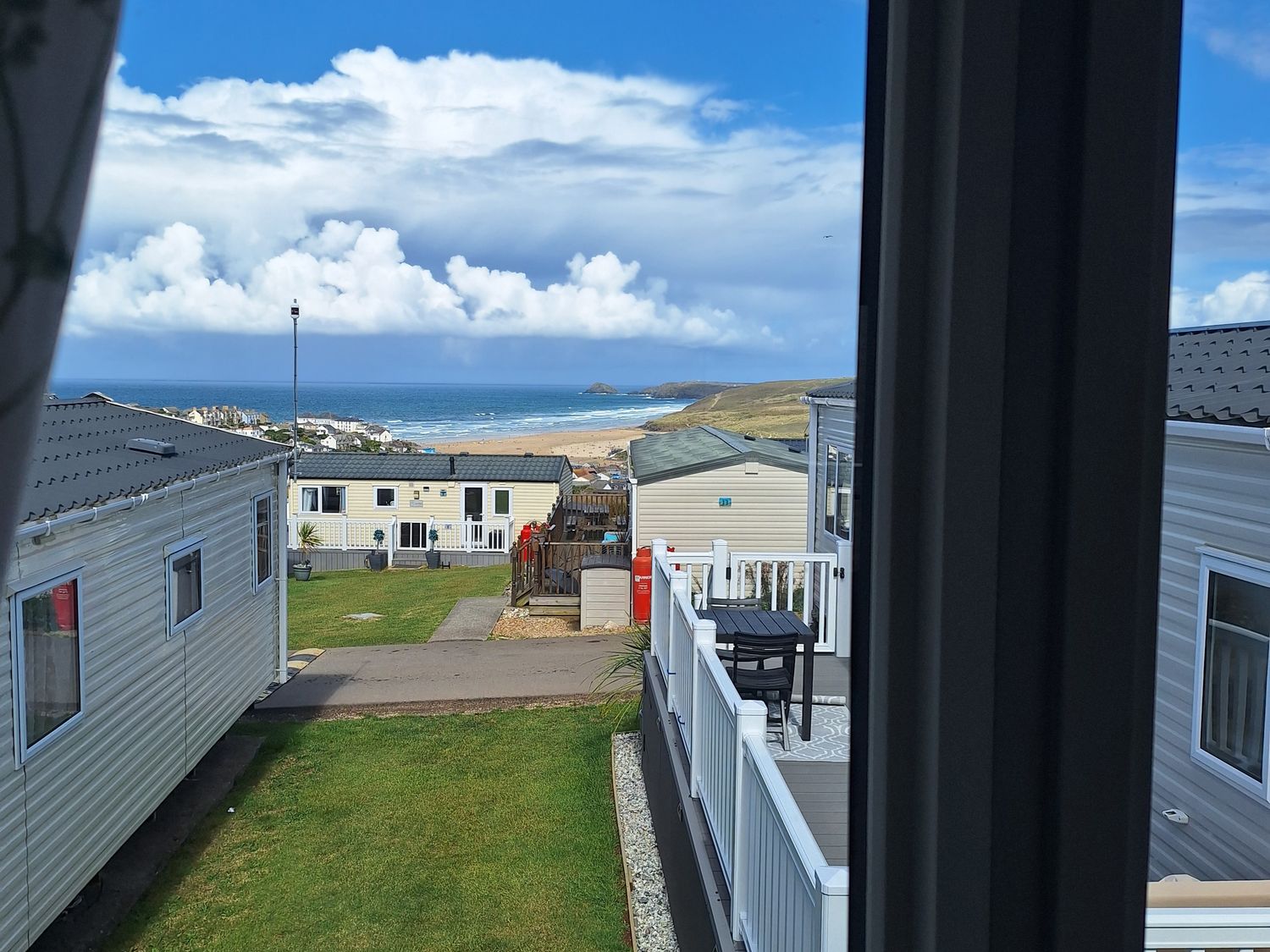 An outdoor view of caravans and the sea at Liskey Hill Caravan Park - Holiday Accommodation 20197 Perranporth