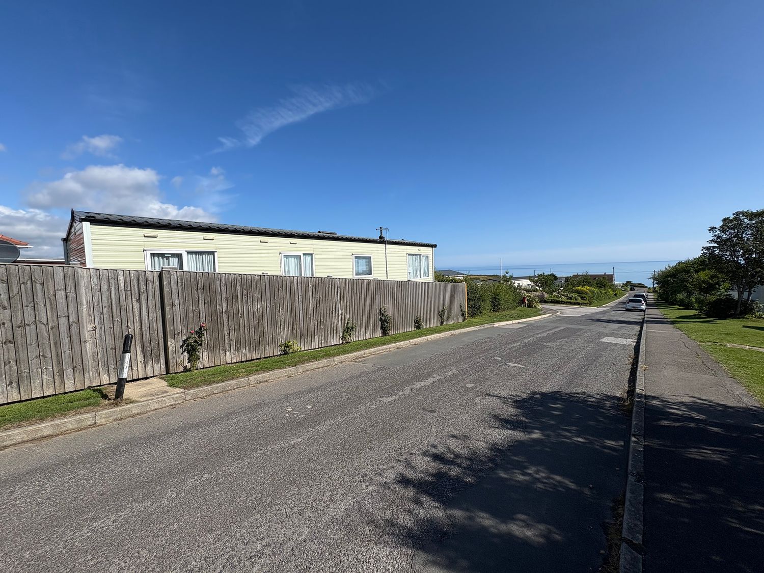 A mobile home along the street with a wooden fence at Newlands (private land) - Holiday Accommodation 22269 Filey