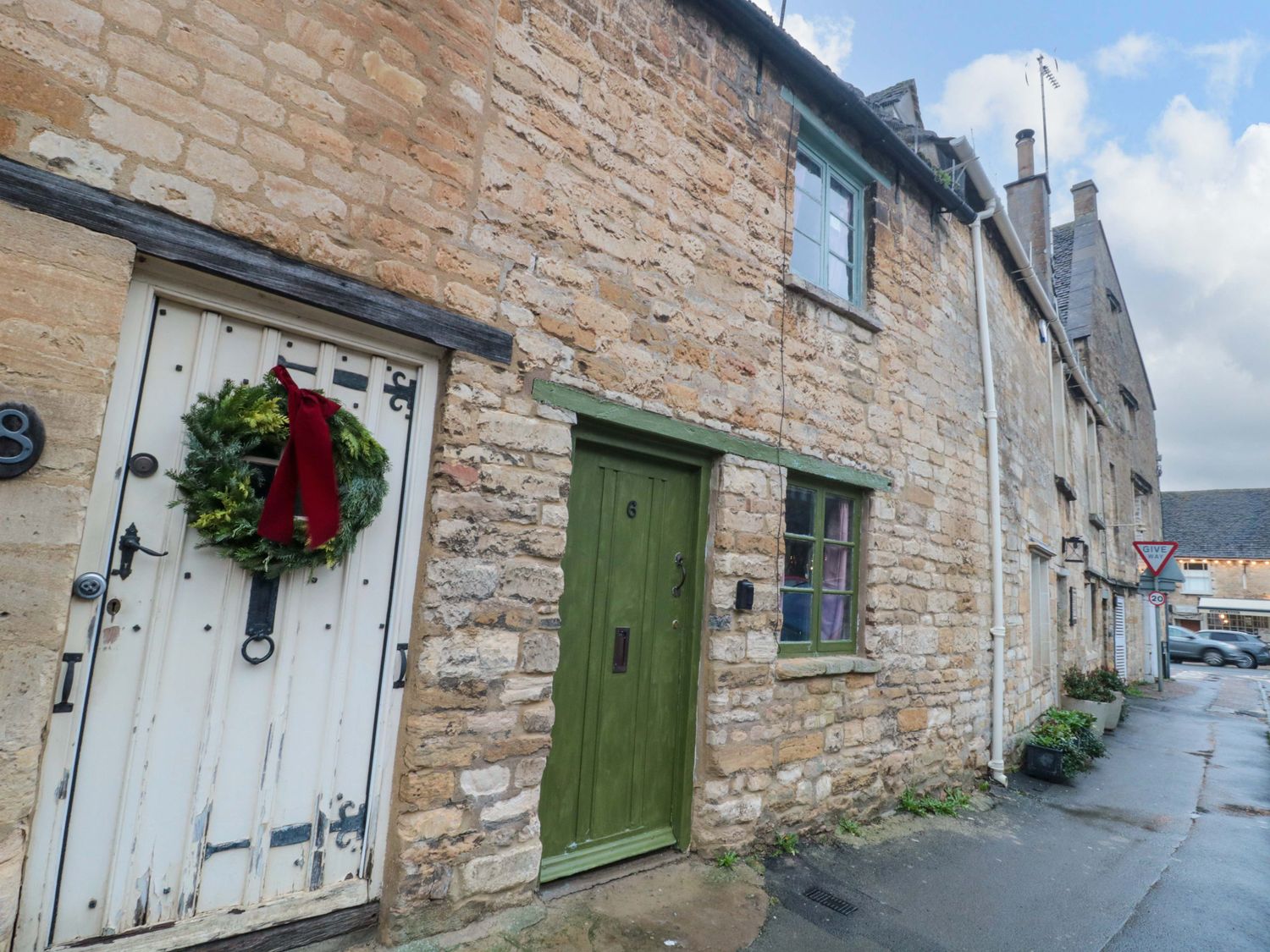 A street view with two doors and stone walls at 6 Priory Lane in Burford