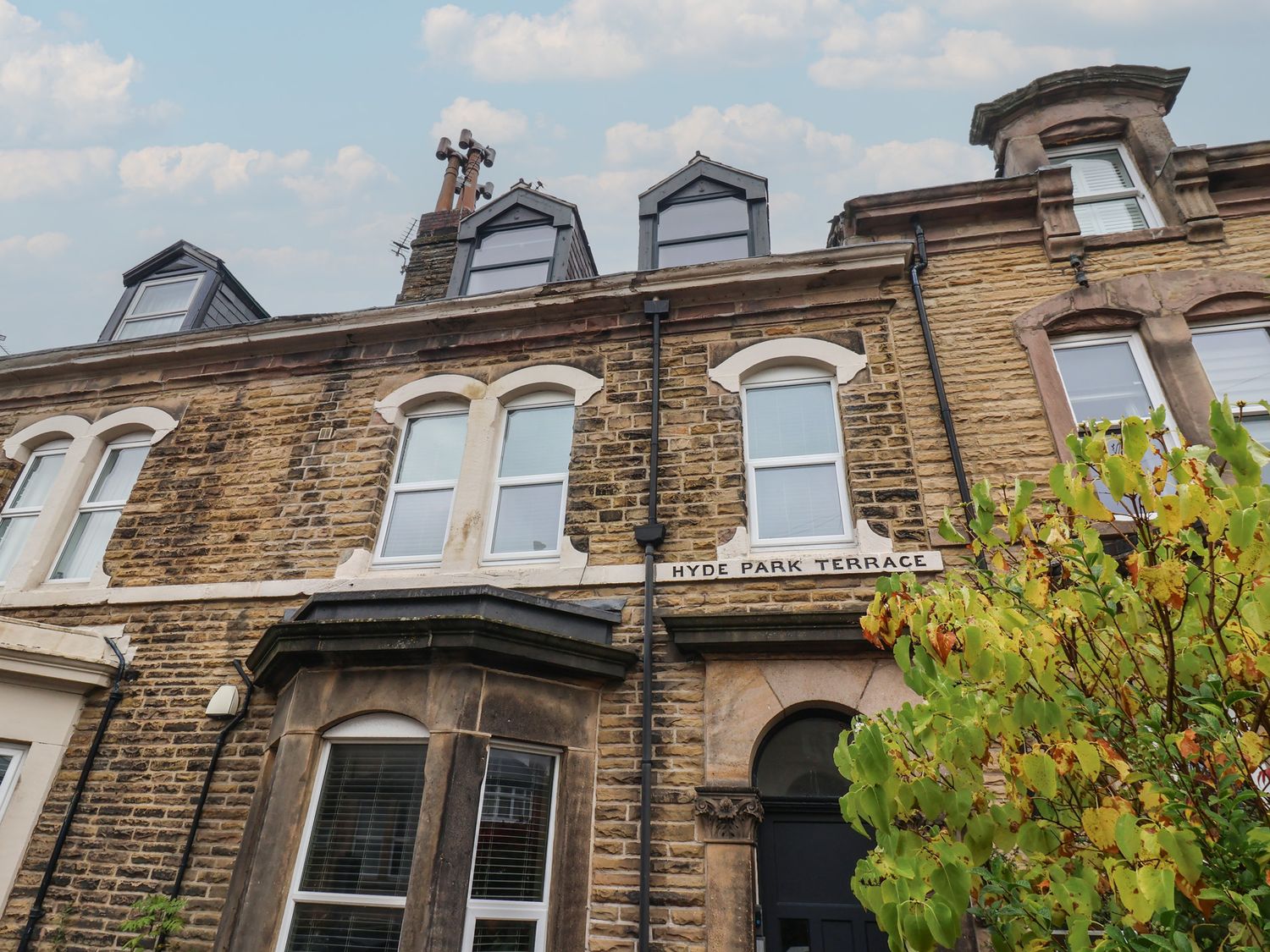 A building with windows and a sign at Flat 2 23 Hyde Park Road in Harrogate