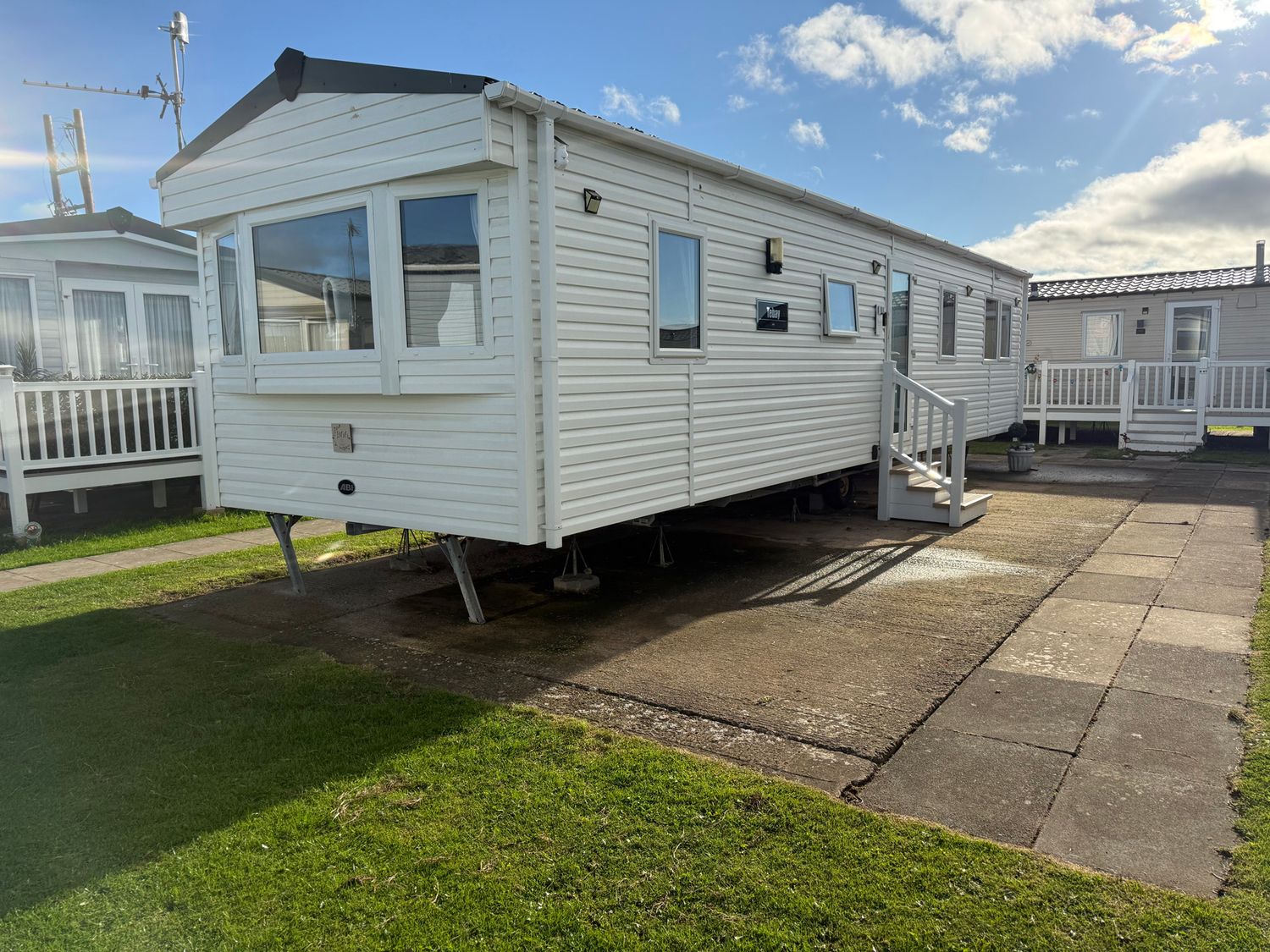 A mobile home with steps and a pathway at Ty Cariad in 