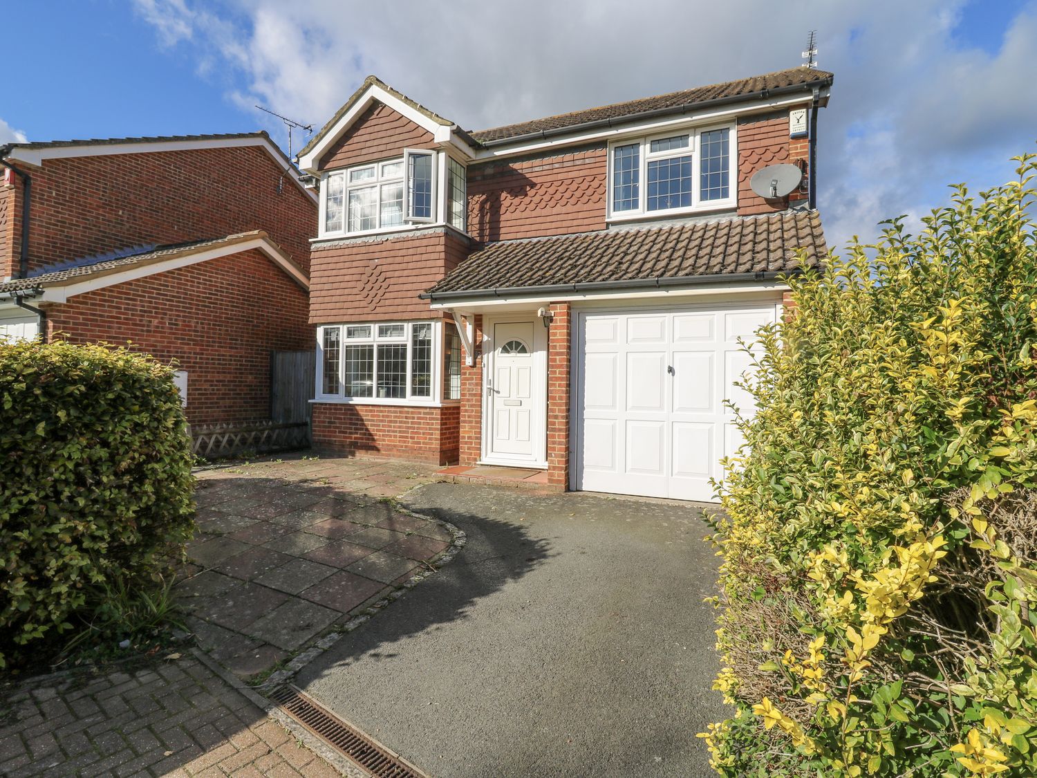 A house with a garage and front door at 32 Abbey Gardens