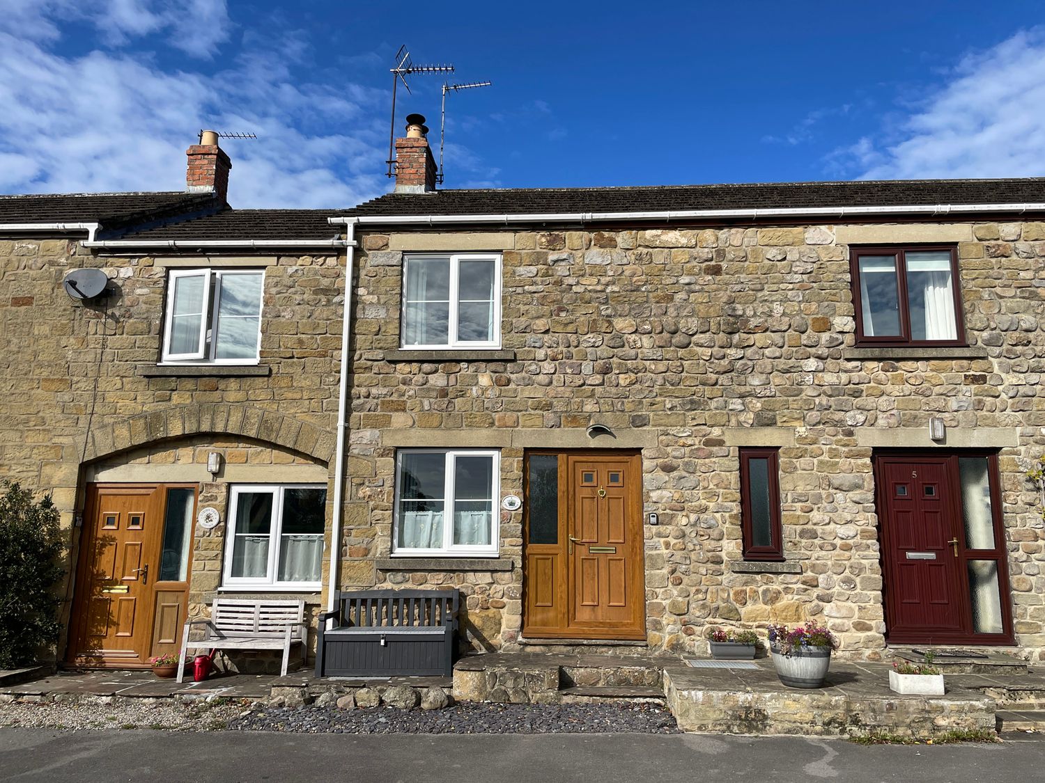 A stone facade with front doors and windows at Tyg Cottage Masham
