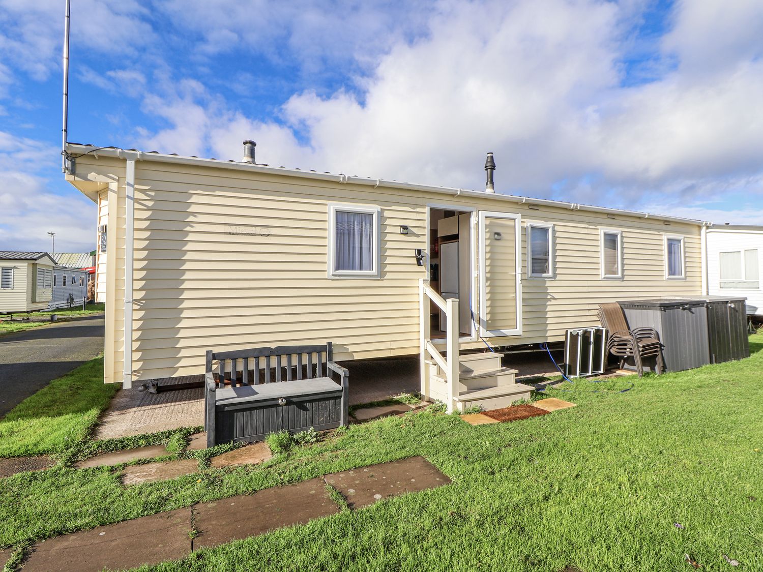 A caravan with steps and bench at Chappie's Caravan - Rhyl 8 Rhyl