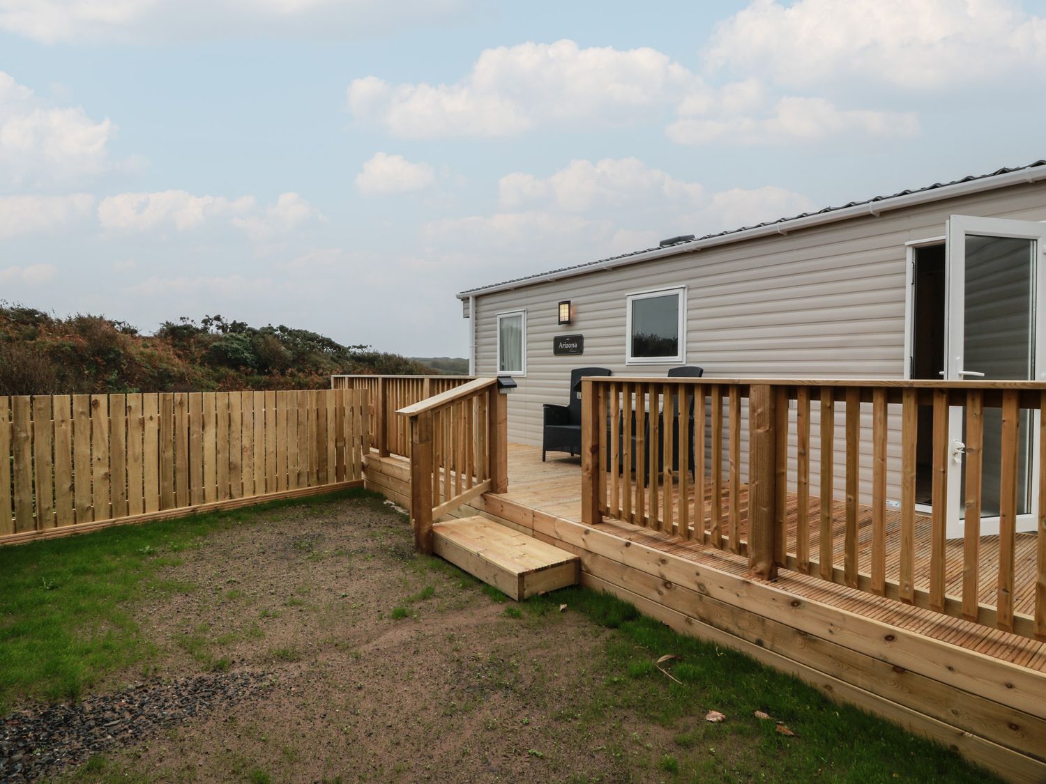 An outdoor area with decking and a building at Ellies House in Stranraer