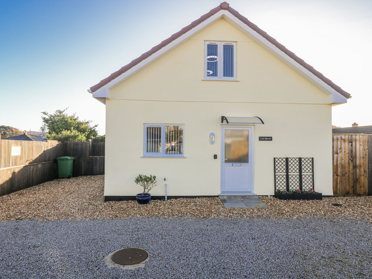 A house with a front door and gravel area at Cosy Retreat in Pool