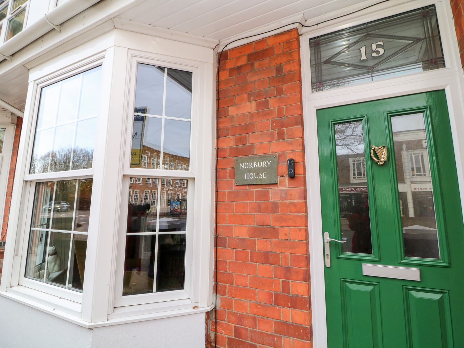 The entrance with a green door and window at Norbury House