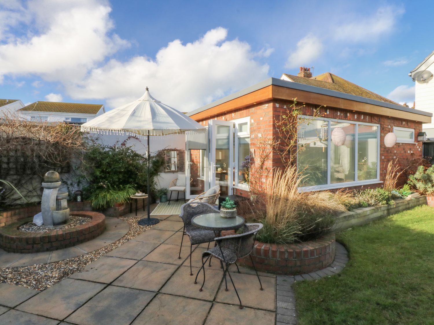 A garden with a patio area and seating at The Summerhouse in Llandudno