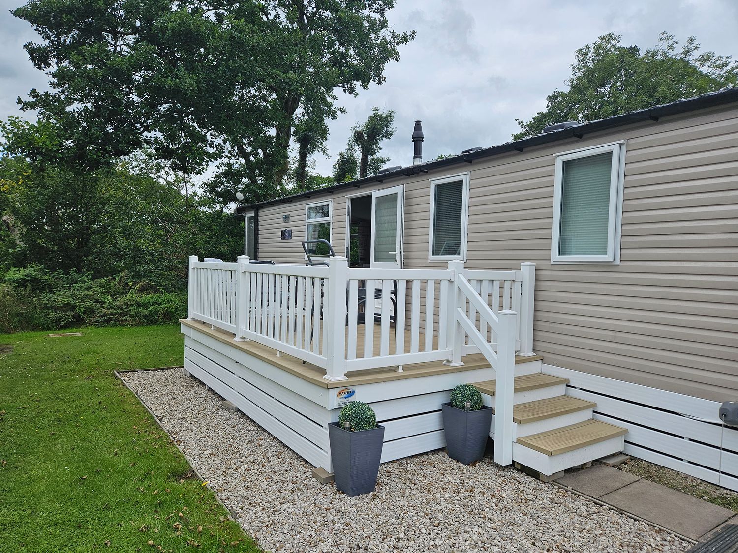 A holiday home with a deck and steps at Woodland View