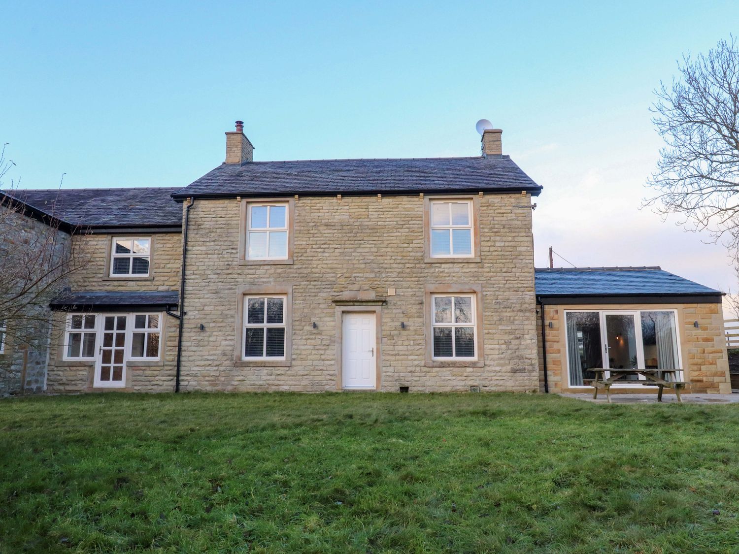 A house with windows and a door at The Farm House in Skipton